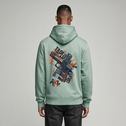 Organic Hoodie 'TAPED & LOADED' – Mann von hinten, mintgrüner Oversize Hoodie mit cinematischem Backprint 'Taped & Loaded'. Heavy Oversize Fit. Premium Cinematic Streetwear. Film Art Wear – Designed in Hamburg.